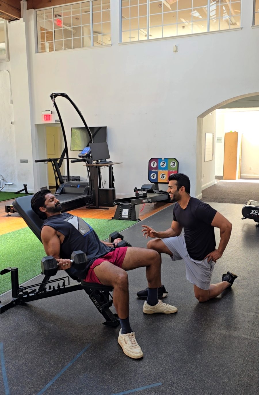 Coaching a dumbbell press on the bench